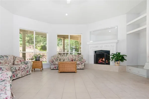 a kitchen with white cabinets and sink