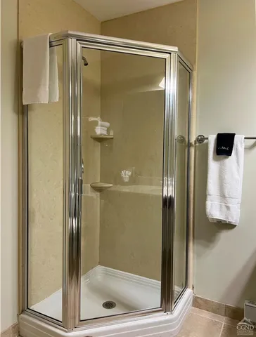 a bathroom with a glass shower door