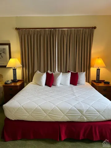 a bedroom with a bed and a lamp