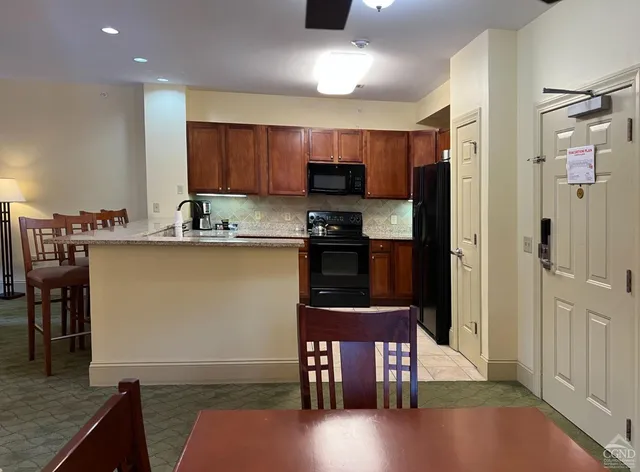 a kitchen with stainless steel appliances granite countertop a stove top oven a sink and cabinets