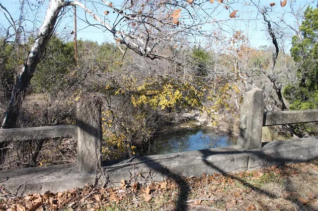 a view of a backyard with wooden fence