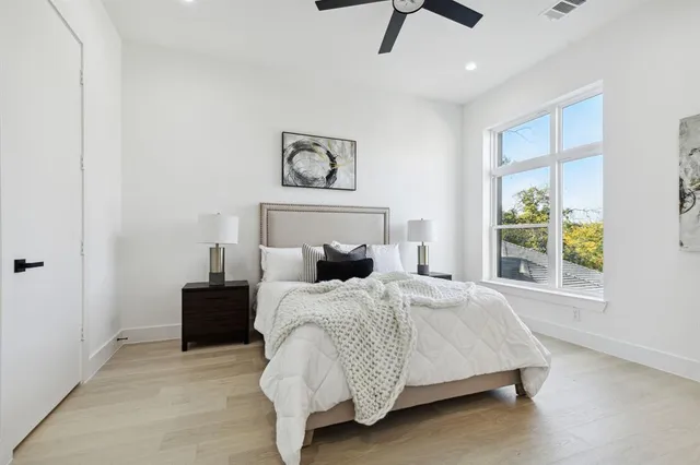 a bedroom with furniture and a large window