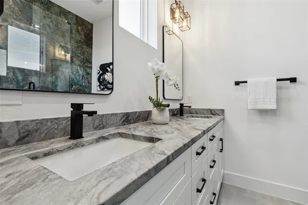 a bathroom with a glass shower door