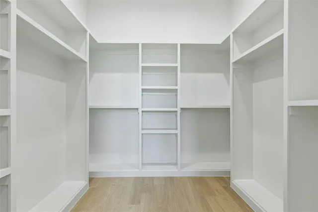 a bedroom with a bed and a lamp