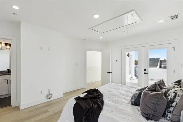 a bedroom with a bed and a large window