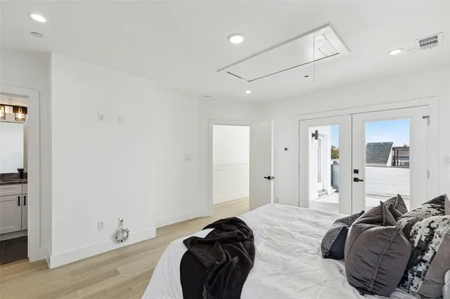 a bedroom with a bed and a large window