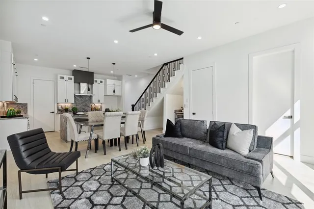 a living room with lots of furniture and a chandelier