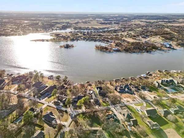 an aerial view of ocean and residential houses with outdoor space