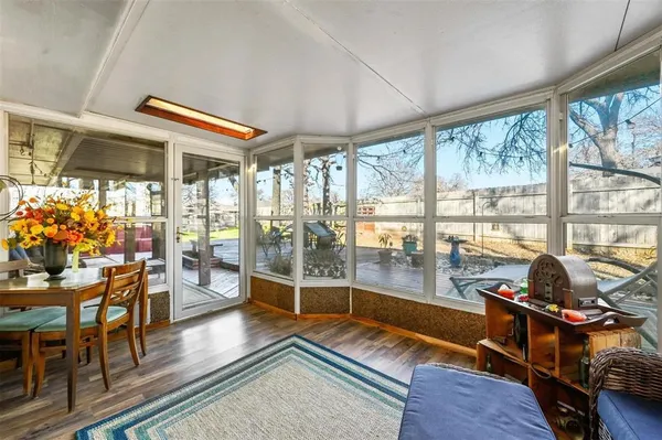 a room with wooden floor and furniture