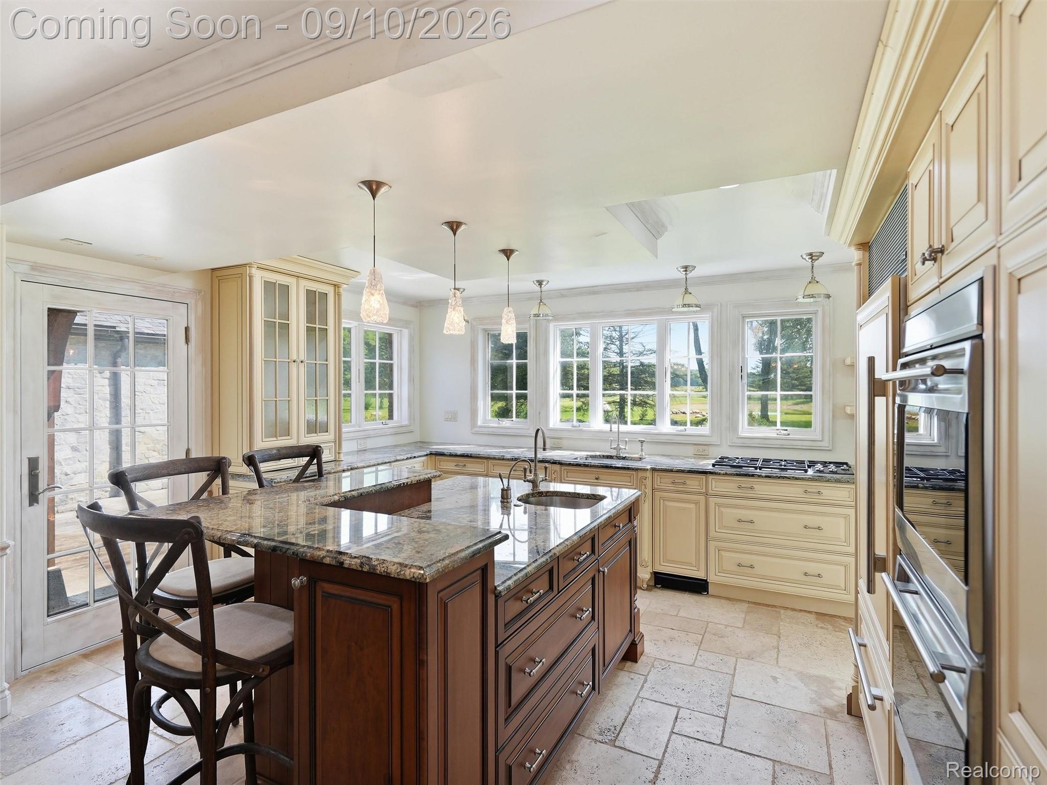 61400 Romeo Plank Road Ray, MI 48096 - Photo 42 of 99 Gourmet kitchen featuring a large central island with seating, stone countertops, integrated stainless steel appliances, and tile flooring