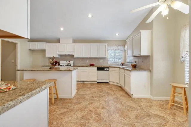 a kitchen with cabinets and a counter top space