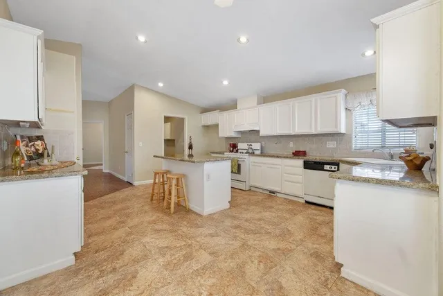 a kitchen with a sink cabinets and window