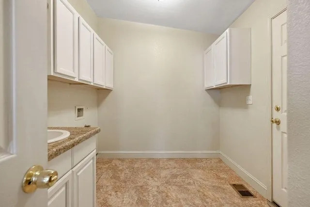 a view of a storage and utility room with a sink