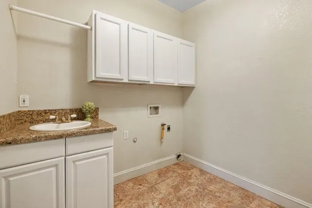 a view of a room with wooden floor and a ceiling fan