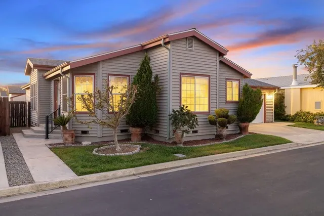 a front view of house with yard and outdoor seating