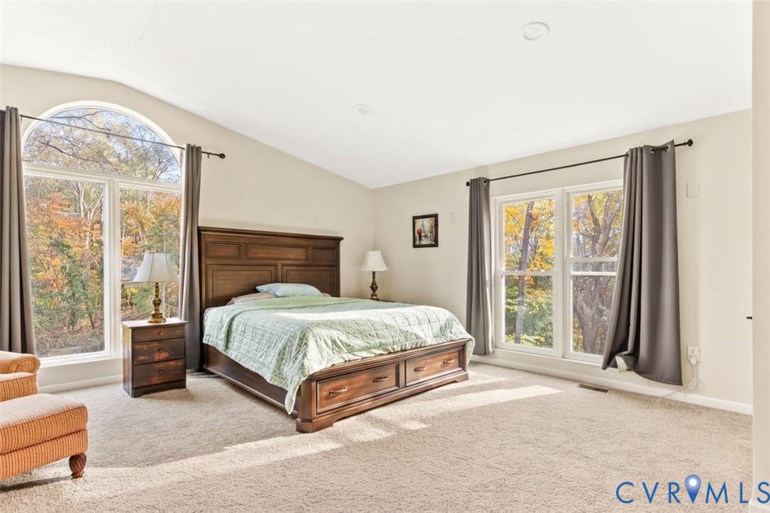 517 West Riverside Drive Lanexa, VA 23089 - Photo 16 of 27 a spacious bedroom with a large bed and a large window