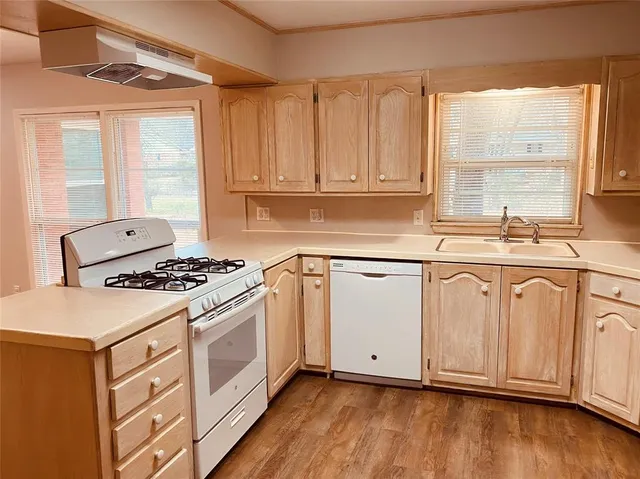 a kitchen with granite countertop white cabinets and white appliances