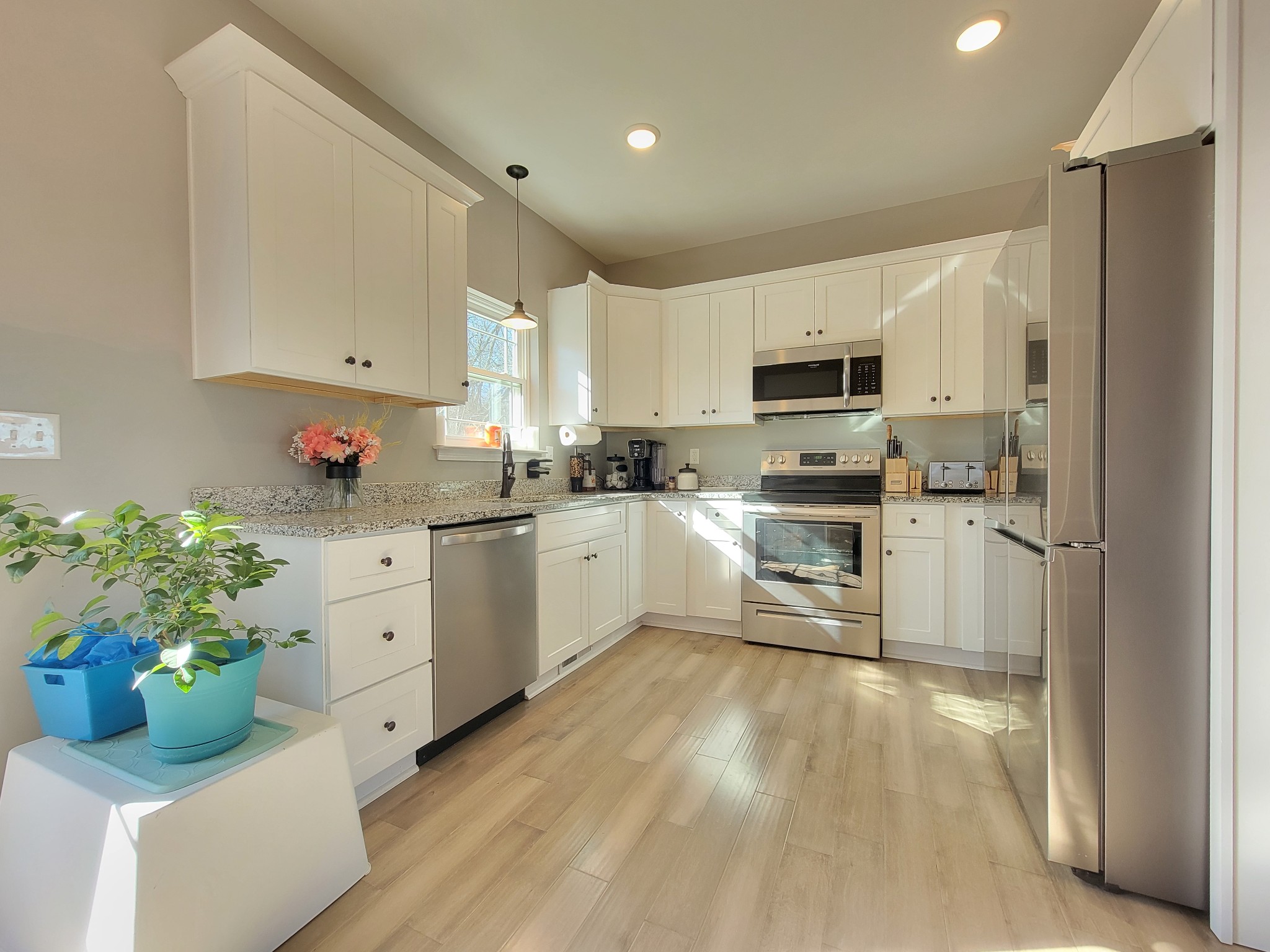 1152 Oak Grove Road Dickson, TN 37055 - Photo 13 of 53 a kitchen with white cabinets stainless steel appliances and a potted plant