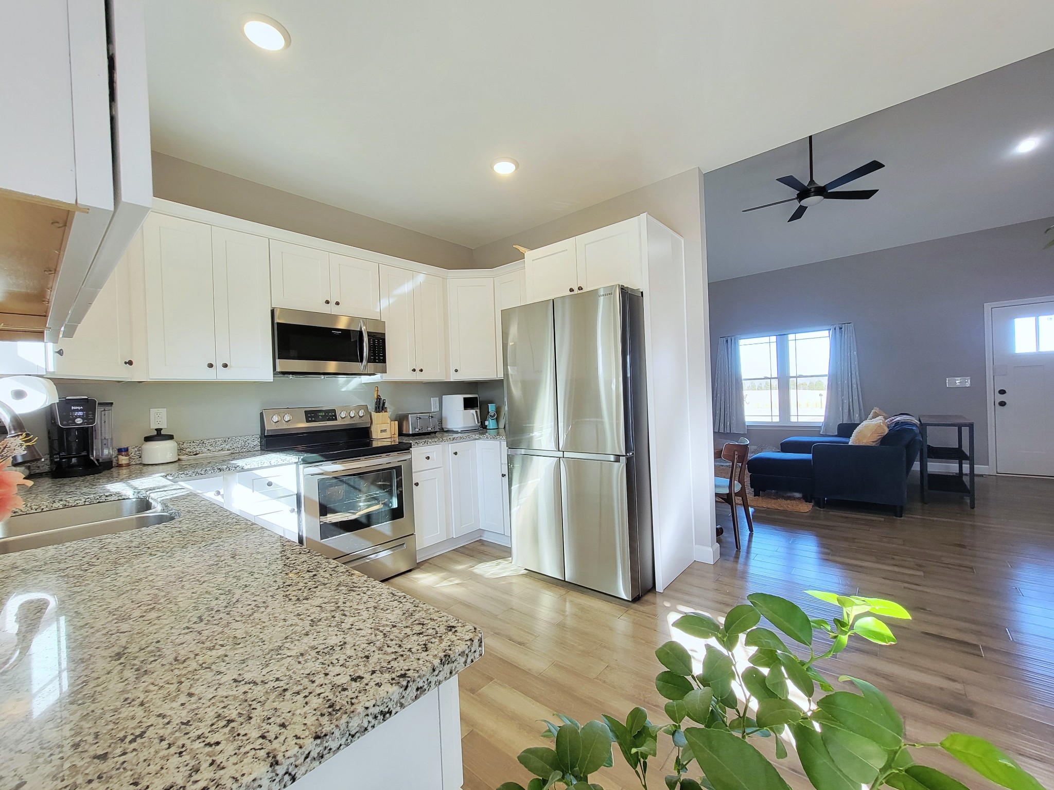 1152 Oak Grove Road Dickson, TN 37055 - Photo 15 of 53 a kitchen with stainless steel appliances granite countertop a refrigerator a stove top oven a dining table and chairs with wooden floor