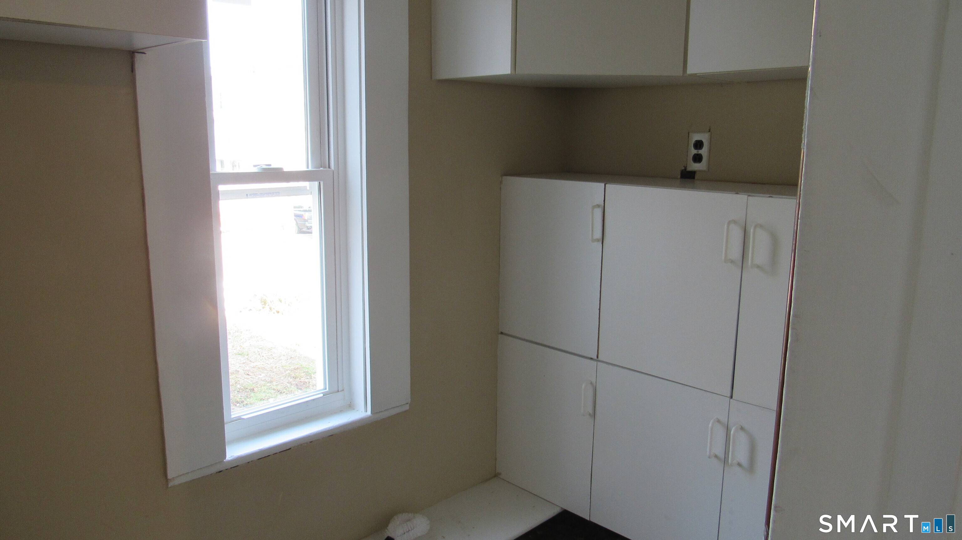 246 North Elm Street Torrington, CT 06790 - Photo 4 of 11 a utility room with cabinet and window