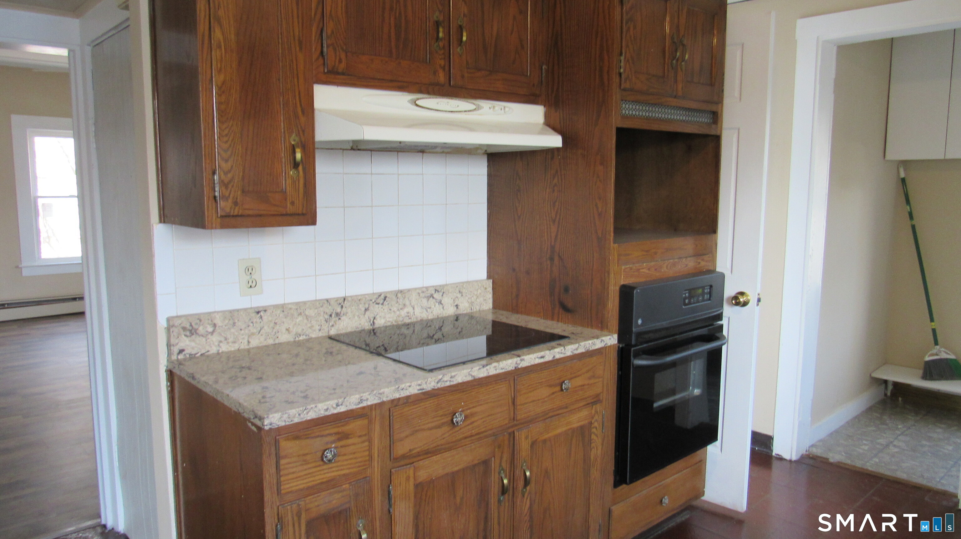246 North Elm Street Torrington, CT 06790 - Photo 5 of 11 a kitchen with a sink and a refrigerator