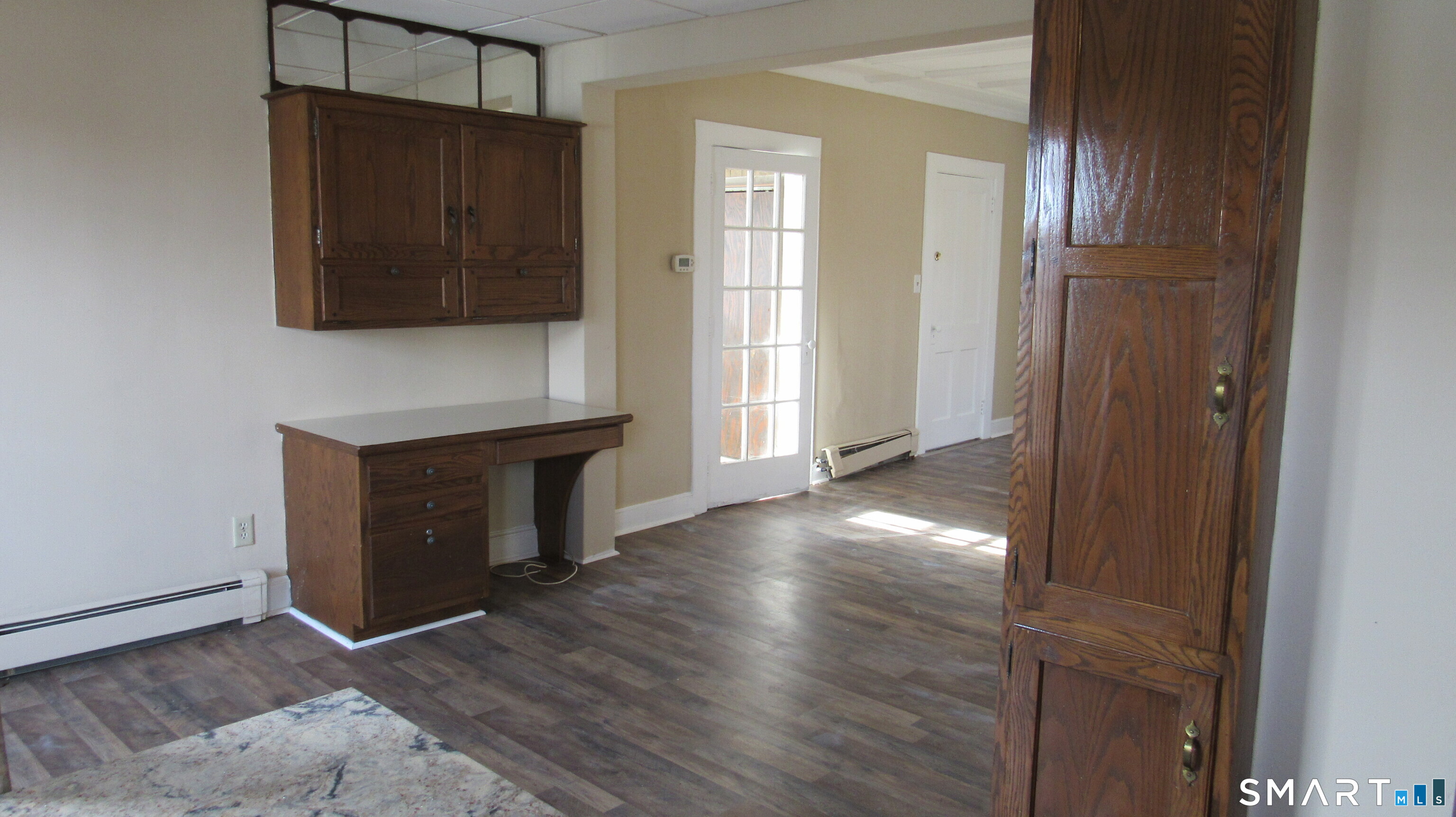 246 North Elm Street Torrington, CT 06790 - Photo 9 of 11 an empty room with wooden floor and cabinet