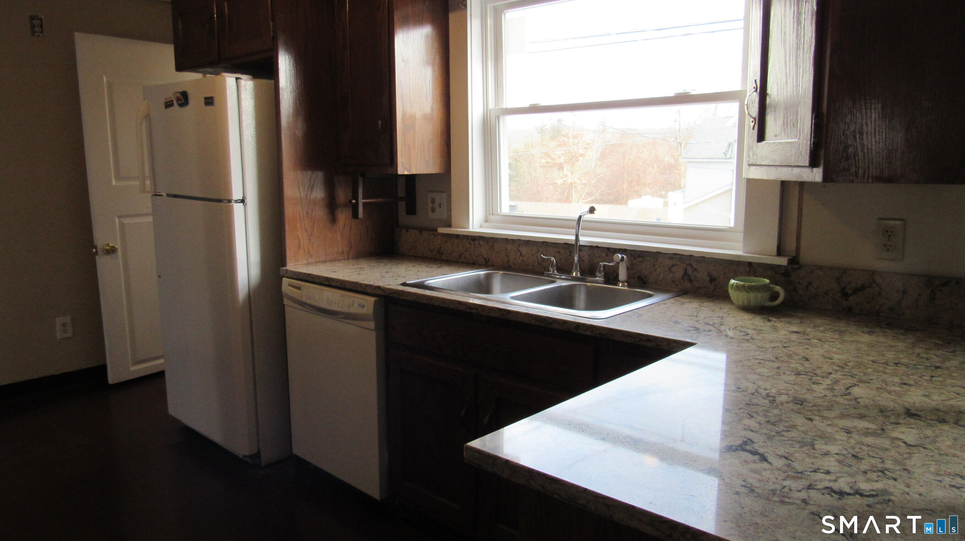 246 North Elm Street Torrington, CT 06790 - Photo 10 of 11 a kitchen with a sink a window and a refrigerator