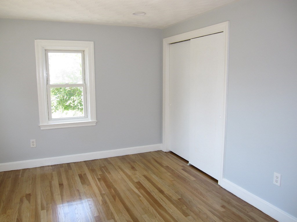 369 Union Street Ashland, MA 01721 - Photo 11 of 22 an empty room with wooden floor and windows