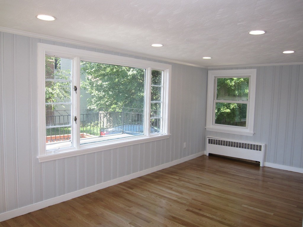 369 Union Street Ashland, MA 01721 - Photo 5 of 22 a view of empty room with wooden floor and fan