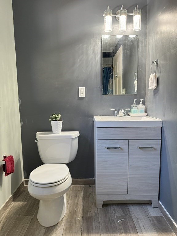 369 Union Street Ashland, MA 01721 - Photo 9 of 22 a bathroom with a toilet sink and mirror