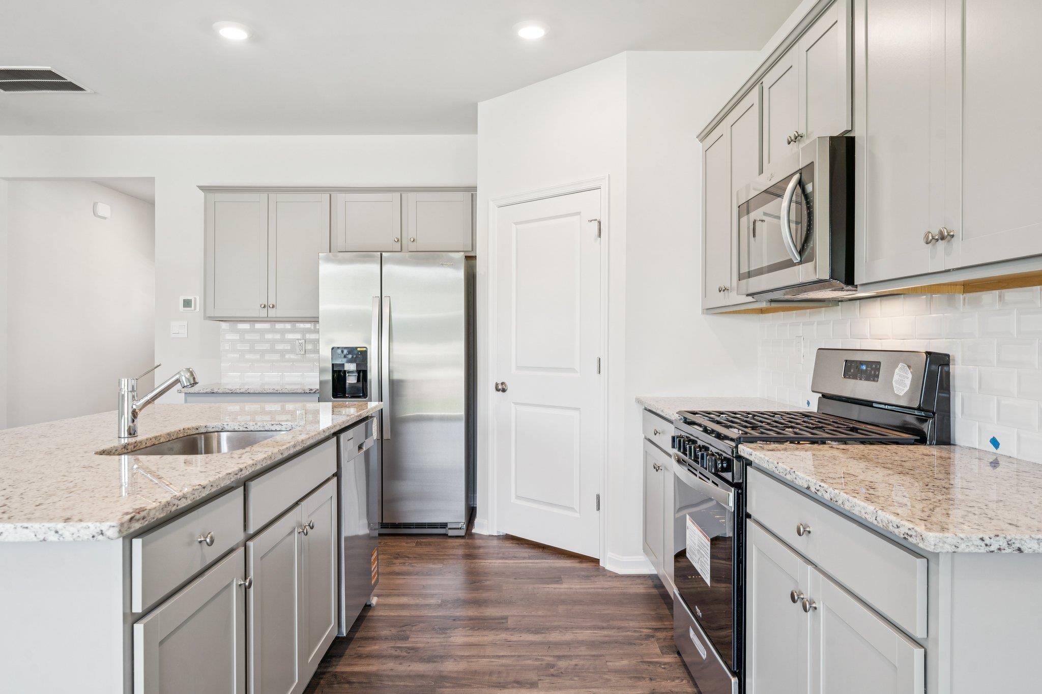 101 Stonewall Jackson Road Waynesboro, VA 22980 - Photo 4 of 30 a kitchen with stainless steel appliances granite countertop a sink stove and refrigerator
