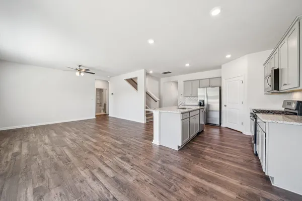 a view of kitchen with wooden floor and electronic appliances