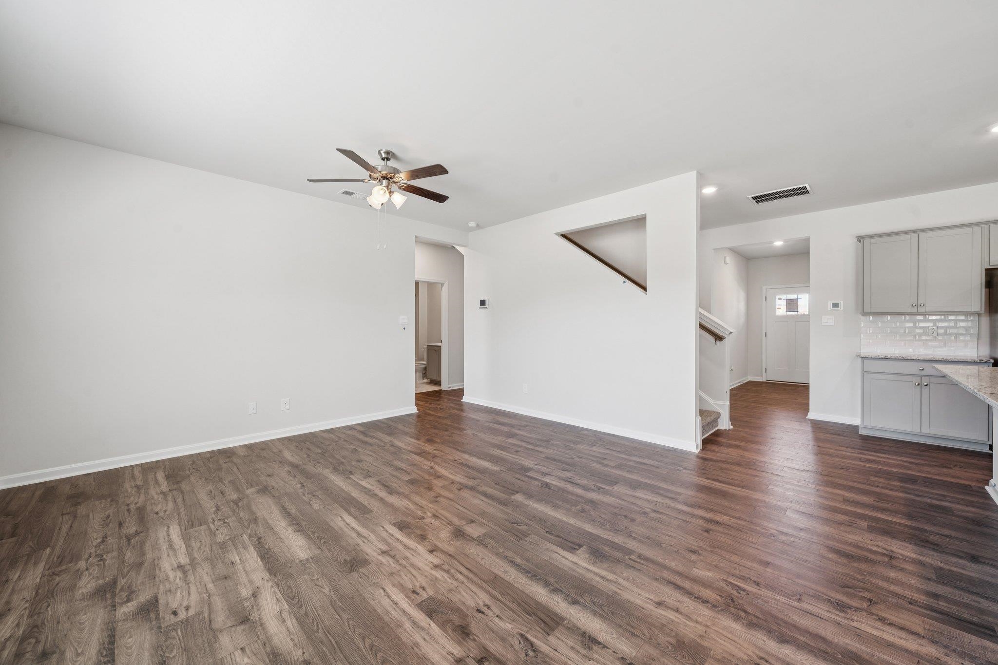 101 Stonewall Jackson Road Waynesboro, VA 22980 - Photo 10 of 30 a view of a kitchen with wooden floor and a ceiling fan