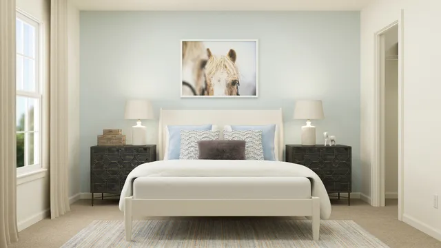 a bedroom with a bed and a painting on the wall