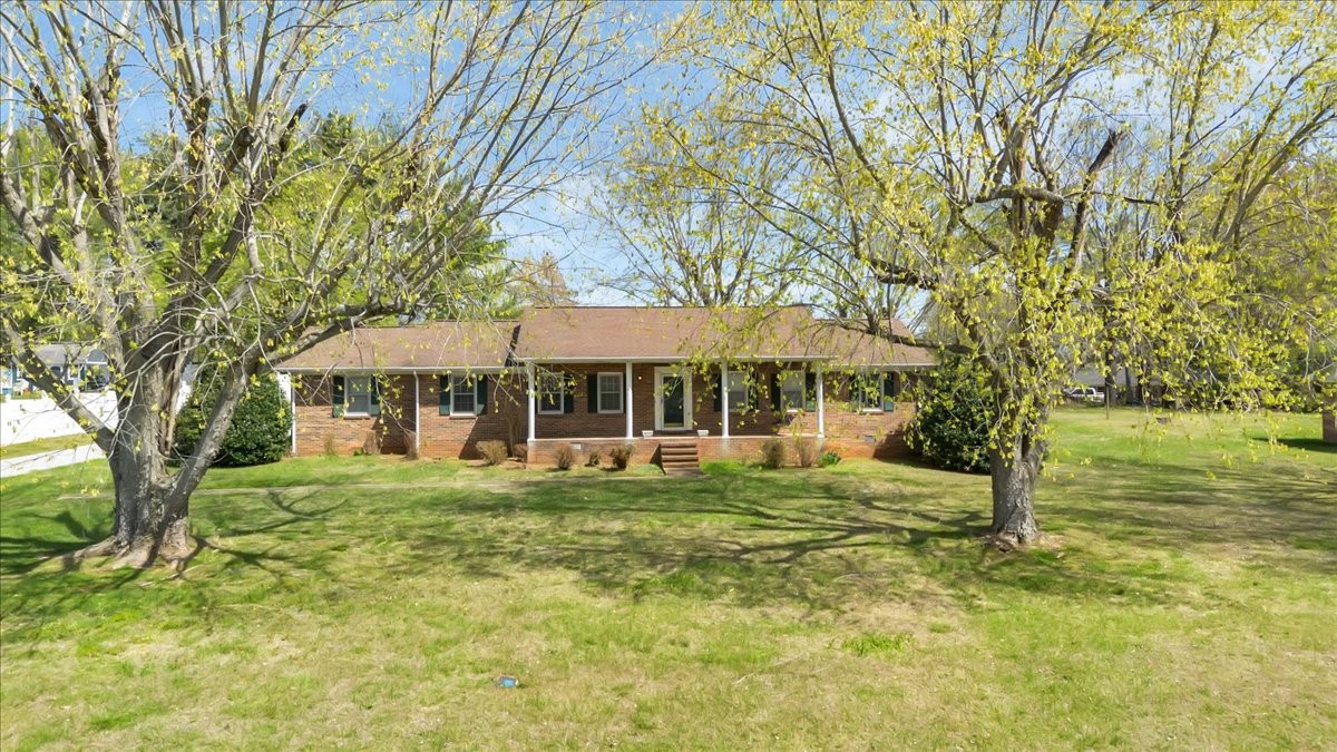 a yellow house in middle of forest