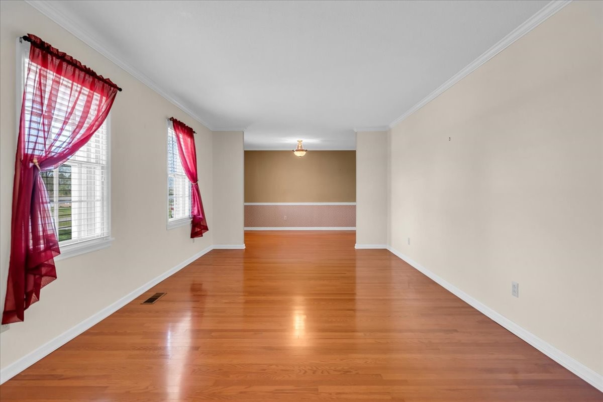 1587 Bypass Road Winchester, TN 37398 - Photo 11 of 26 a view of an empty room with wooden floor and a window