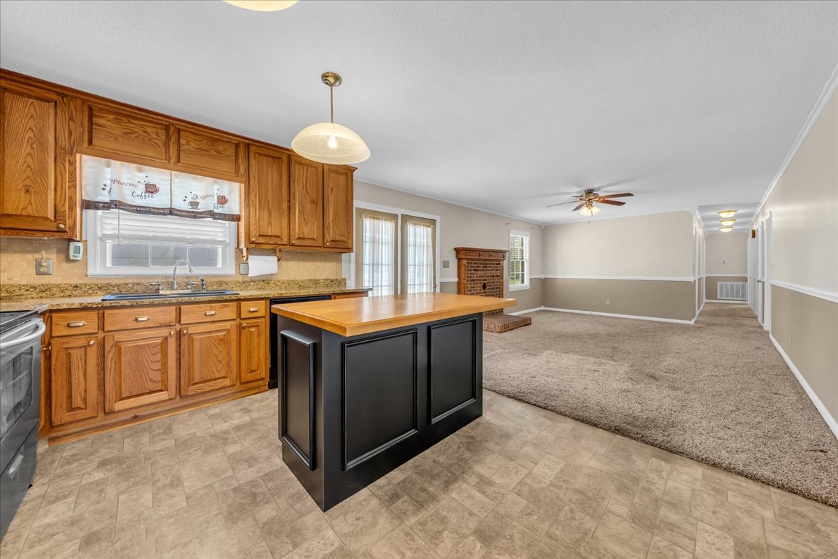 1587 Bypass Road Winchester, TN 37398 - Photo 14 of 26 a kitchen with a stove a sink and a refrigerator