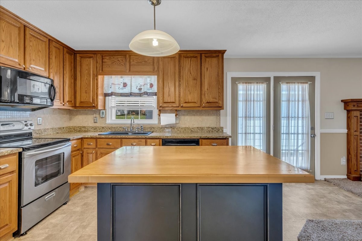1587 Bypass Road Winchester, TN 37398 - Photo 15 of 26 a kitchen with stainless steel appliances granite countertop a sink a stove counter space and cabinets