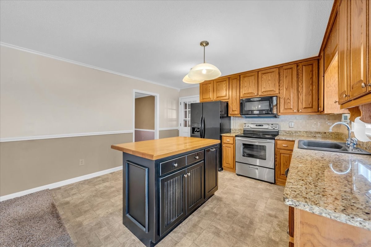 1587 Bypass Road Winchester, TN 37398 - Photo 17 of 26 a kitchen with a stove a sink and a refrigerator