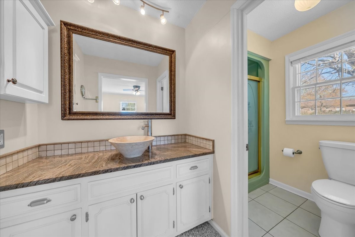 1587 Bypass Road Winchester, TN 37398 - Photo 22 of 26 a bathroom with a toilet a sink and mirror
