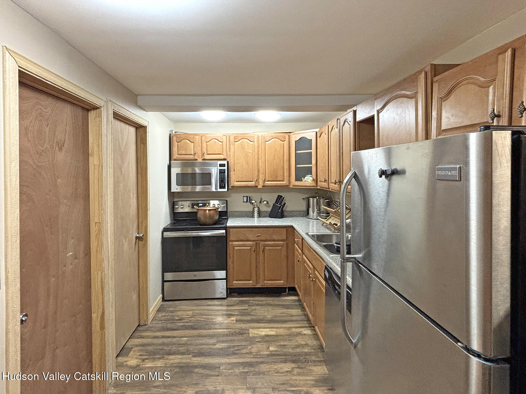 14 Park Road Chichester, NY 12416 - Photo 31 of 37 a kitchen with a refrigerator and white cabinets