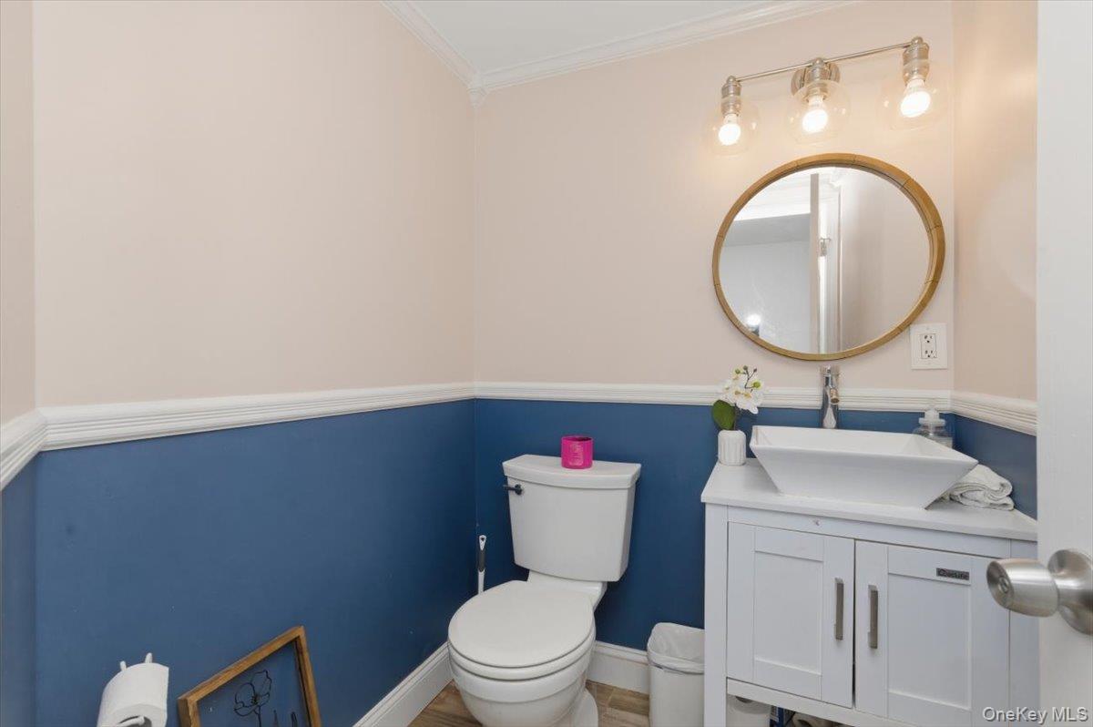 10 Rutgers Road Farmingville, NY 11738 - Photo 12 of 27 a bathroom with a toilet sink vanity and mirror