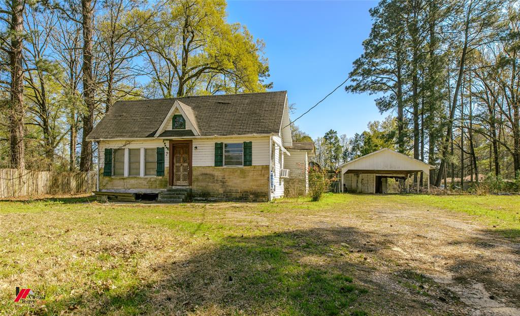 179 Daniel Thomas Road Springhill, LA 71075 - Photo 30 of 37 View of front facade featuring entry steps, a detached carport, fence, and a front yard