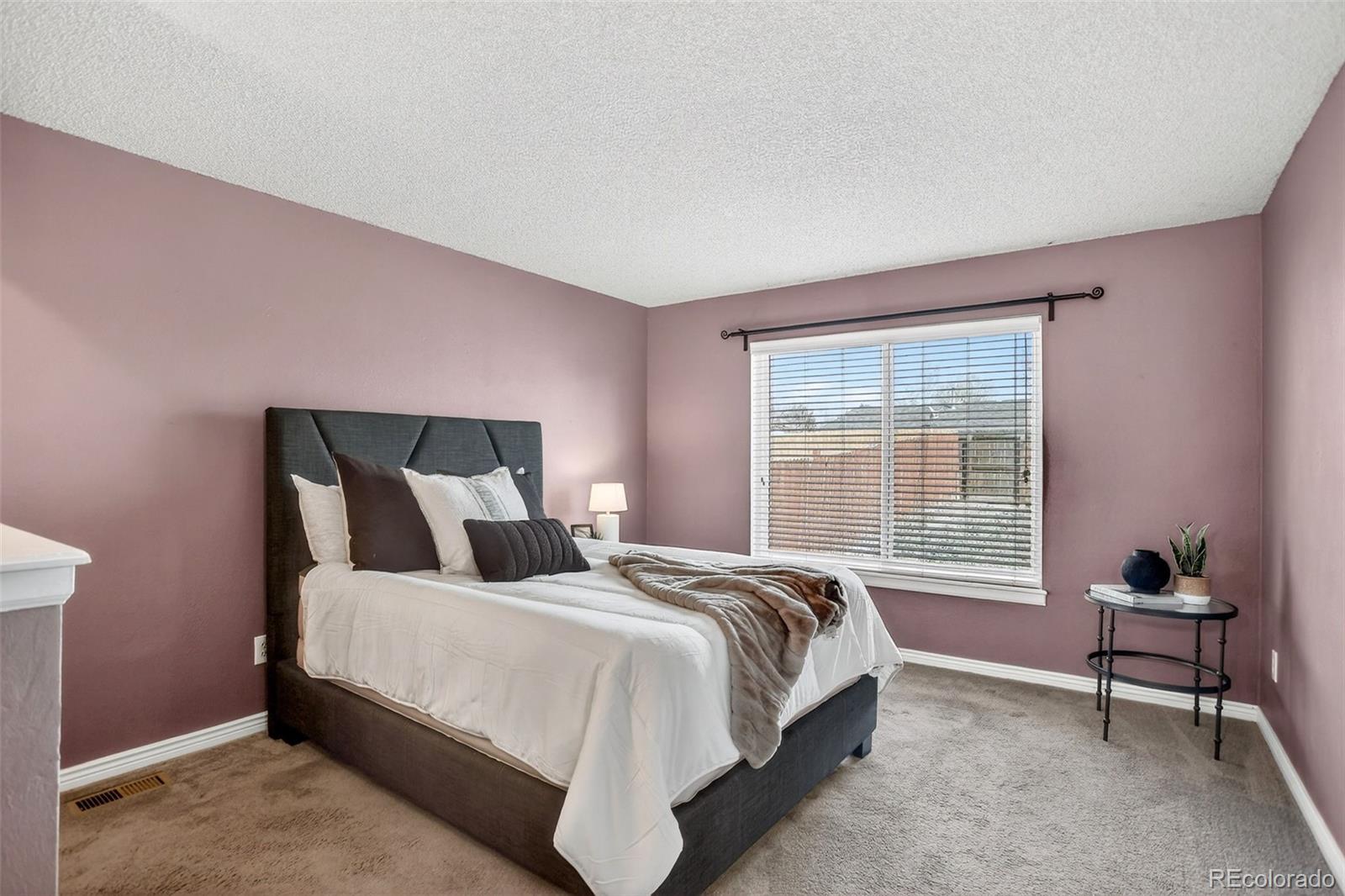 4550 Eugene Way Denver, CO 80239 - Photo 11 of 21 a bedroom with a bed and a window