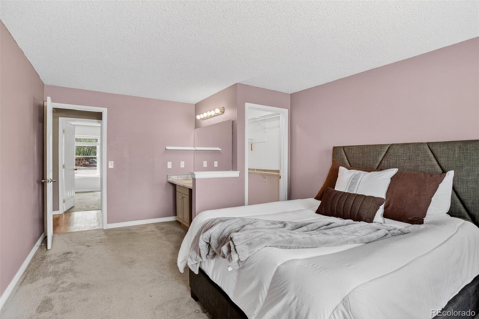 4550 Eugene Way Denver, CO 80239 - Photo 12 of 21 a bedroom with a bed and a painting