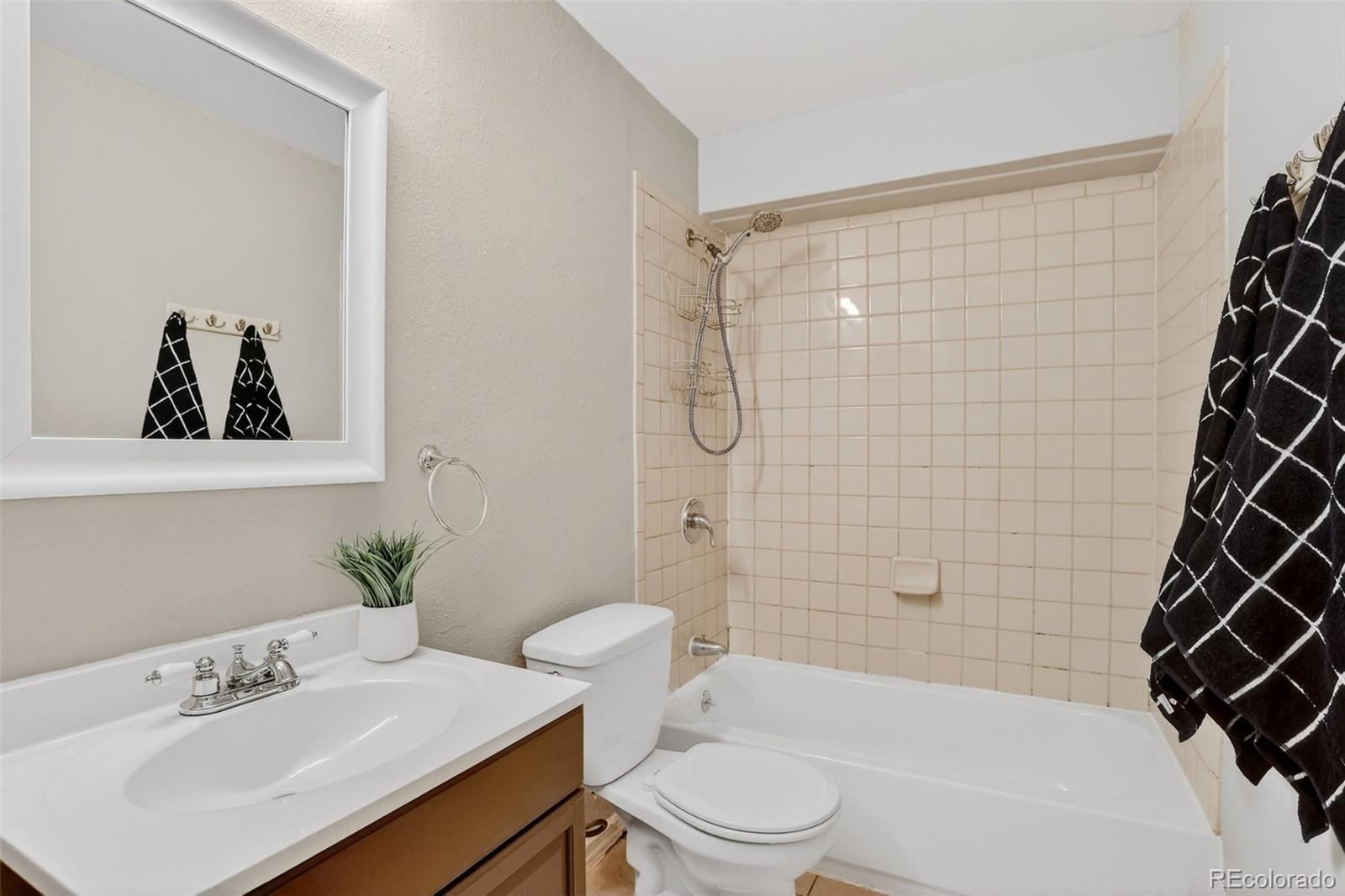 4550 Eugene Way Denver, CO 80239 - Photo 13 of 21 a bathroom with a sink a toilet and shower