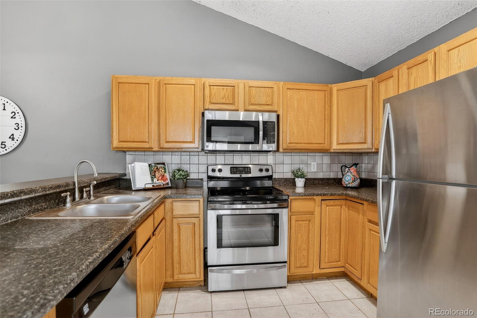 4550 Eugene Way Denver, CO 80239 - Photo 8 of 21 a kitchen with a stove a sink and a microwave