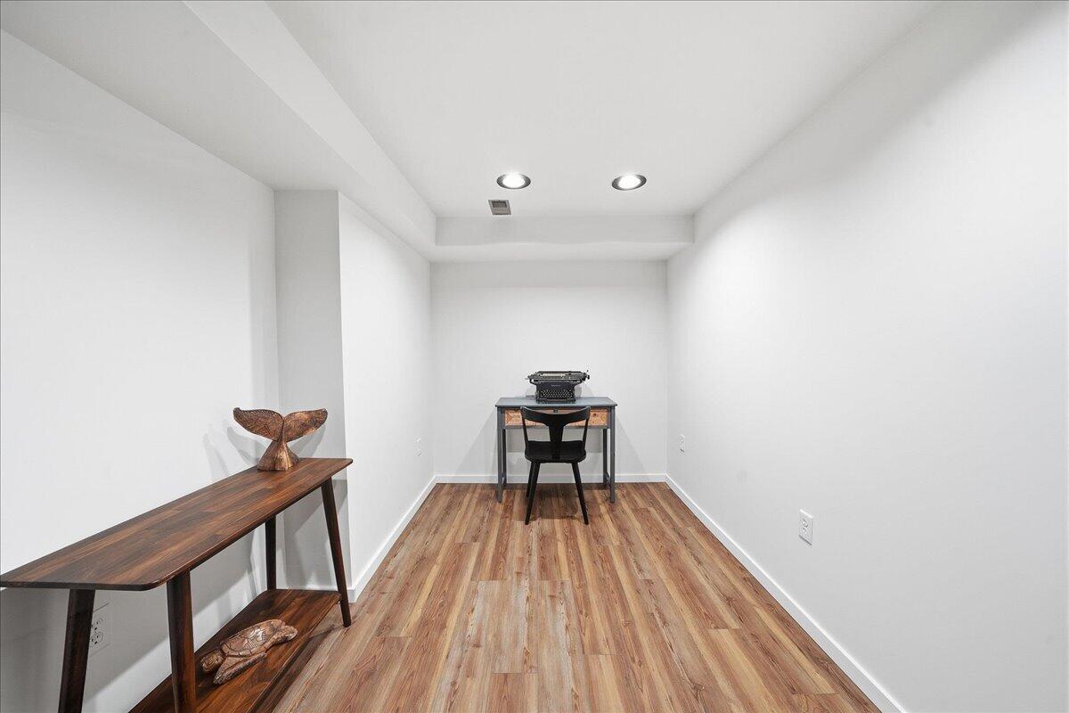 63 Ski Hill Road Portage, IN 46368 - Photo 18 of 28 a view of a hallway with wooden floor and a potted plant