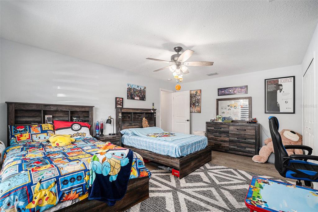 7403 Northeast 22nd Ct Road Ocala, FL 34479 - Photo 27 of 37 a bedroom with two beds and a baby crib