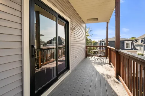 a view of a balcony with wooden floor